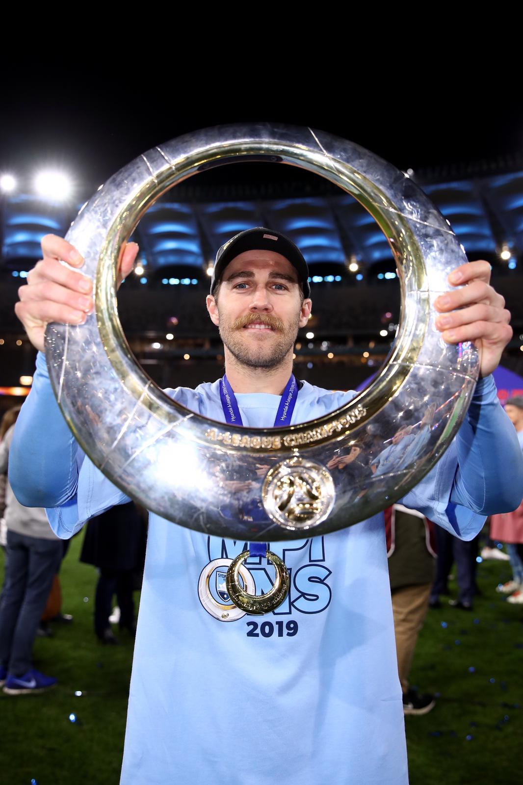 Josh Brillante lifting the A-League championship trophy