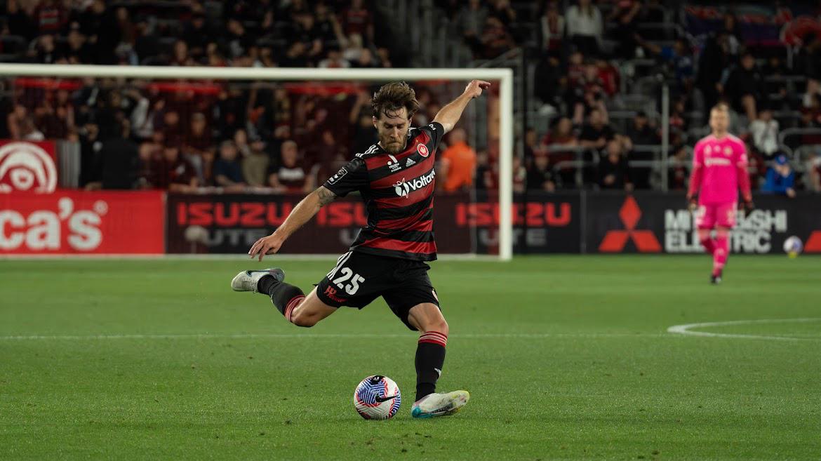 Josh Brillante striking the ball in an A-League match